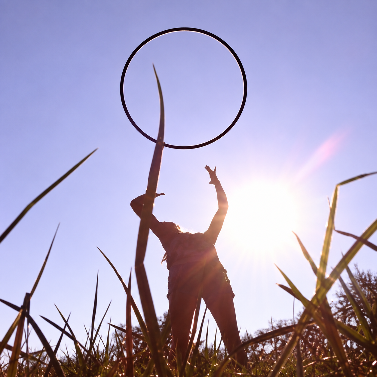 Cinnamon Tidwell hoop dancing in sunlight