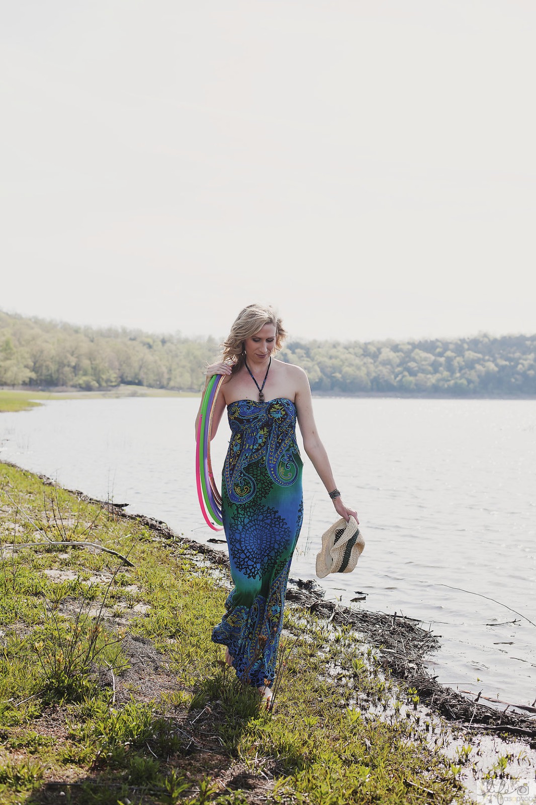 Michele standing by the water holding a colorful set of hoops
