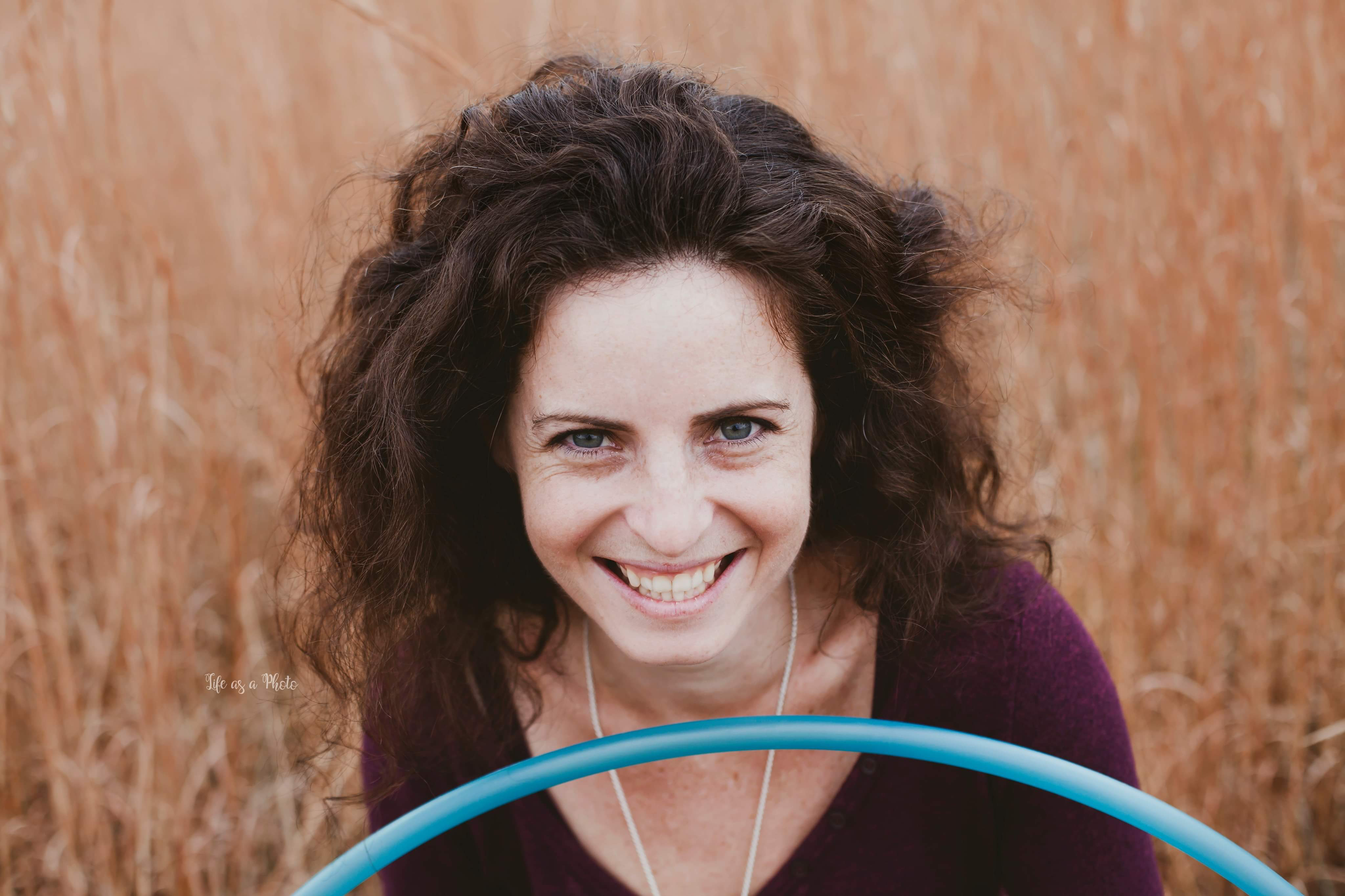 Caterina Suttin Holdbrook smiling behind a hoop